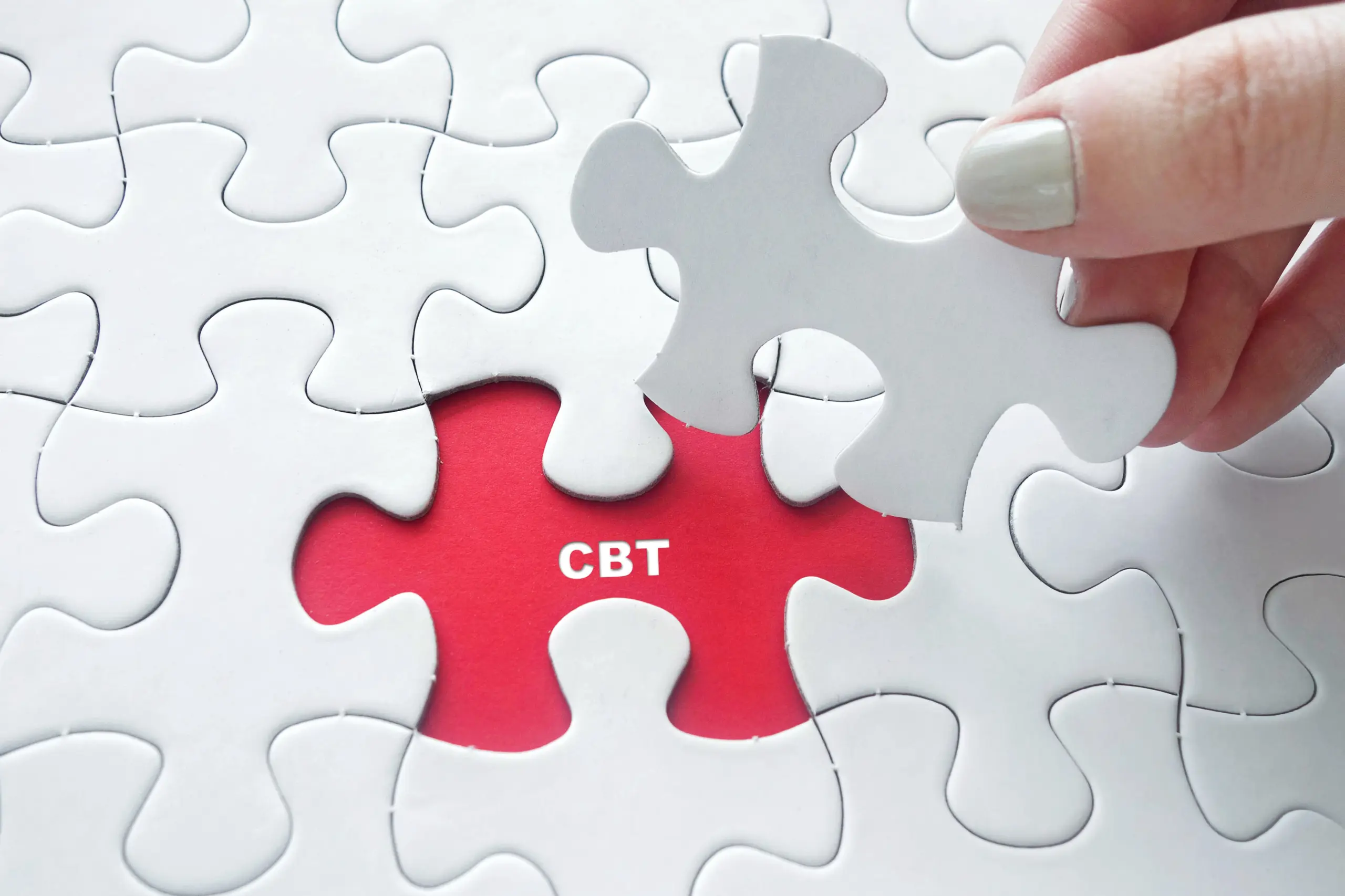 Close up of girl's hand placing the last jigsaw puzzle piece with word CBT (Cognitive Behavioral Theraphy) as Stress Relief Technique