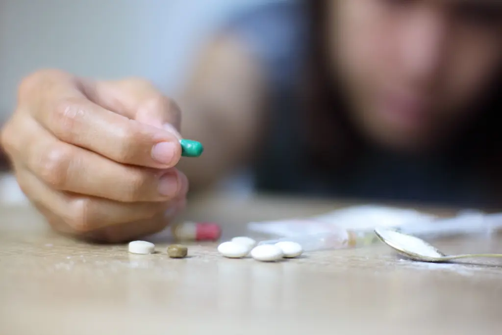 drug addict asian young woman hand holding PCP drugs